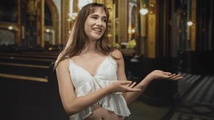 clip-3984258983-woman-smiling-presenting-open-palms-midriff-visible