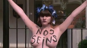 Activists of Femen topless protest outside the embassy of Ukraine in Europe