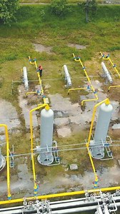 Gas production. Large gas distribution complex. A gas worker or a station operator shuts off the gas supply. Gas production station located in the mountains.