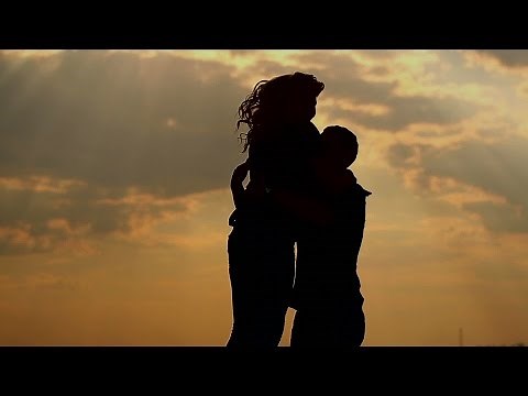 Silhouette of couple in love outdoors. Sunset.