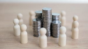 Wooden figures encircling stacks of coins, representing finance and collective investment | Premium Stock Video Footage