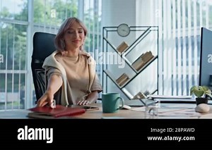Blonde lady flipping notebook working computer in open space office closeup. Focused woman looking monitor analysing financial report at workplace. Beautiful female professional staring pc screen Stock Video Footage - Alamy