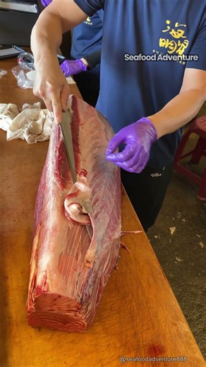 What is he slicing this massive meat with thick black skin #meatcutting #foodie