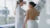 In the Hospital, Mammography Technologist / Doctor adjusts Mammogram...