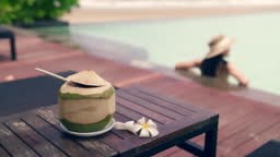 Luxury travel woman on the beach Sit on a beach chair by the pool.