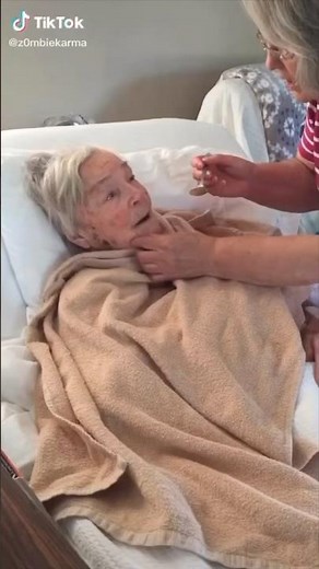 Grandma dipping snuff in bed