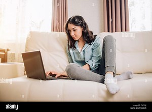 Full length portrait of brunette sitting with laptop computer, laughing watching funny video from social networks. Pretty woman with positive smile re Stock Photo - Alamy