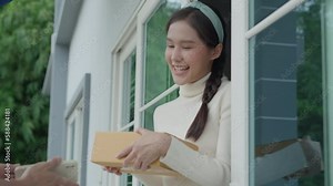 Happy smiling woman receives bag parcel from courier in front house. Delivery man send deliver express. online shopping, paper containers, takeaway, postman, delivery service, packages