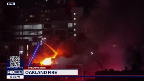 Unoccupied apartment building burning in Oakland
