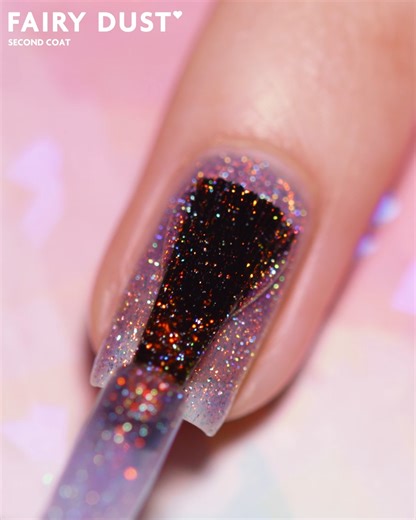 3.3K views · 167 reactions | Unveil the magic of Fairy Dust, a magical violet jelly glimmering with vibrant orange sparkle and a touch of holographic enchantment.✨ Watch as each stroke of the brush transforms your nails into a mesmerizing spectacle, effortlessly twinkling with every flicker of light!栗‍♀️ — #ILNP #ILNPFairyDust #ilovenailpolish #crueltyfree #veganbeauty #shimmernails #holographicnails #purplenails #satisfyingvideo | ILNP Cosmetics | Facebook