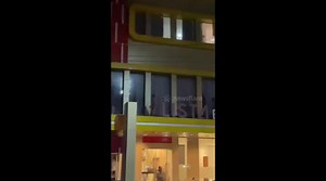 Crazed half-naked local leaps from hotel onto power lines like Superman