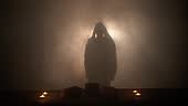 The silhouette of Jesus Christ in ambient, glowing light and smoke...