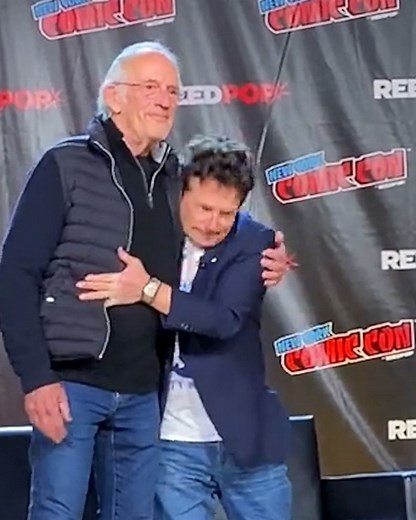 Michael J. Fox and Christopher Lloyd share a hug at New York Comic Con