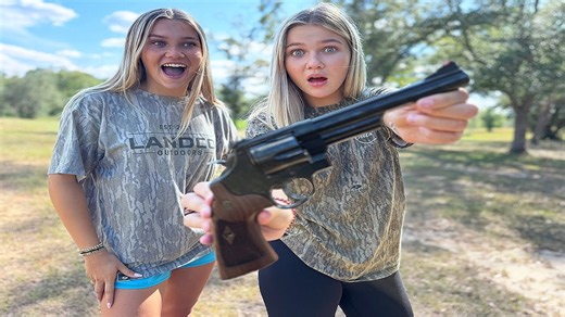 Grandpa lets the twins try a large handgun