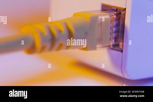 Macro close up of WiFi extender in electrical socket on the wall with ethernet cable plugged in Stock Video Footage - Alamy