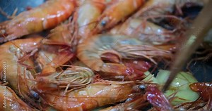 close up stir fry shrimps in wok. Cooking seafood