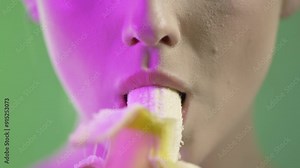Woman eating banana seductively, close up mouth detail
