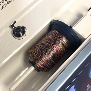 Have you ever sewn with variegated thread? It can give your project some cool effects! Place stabilizer behind your fabric. Experiment with stitch lengths and widths, as well as different variegated threads to achieve different looks. #singersewingmachine #singersewingcompany #itstartswithastitch #tipsandtricks | Singer Sewing