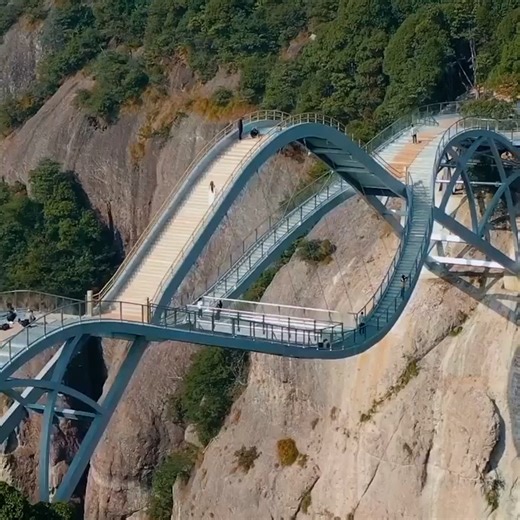 It takes some guts to walk across this bridge. Located in China's Taizhou City, Ruyi Bridge spans the east and west sides of the canyon in Shenxianju. #gigadgets #bridge #travelislife #bridgephotography #buildingdesign | GIAdventure