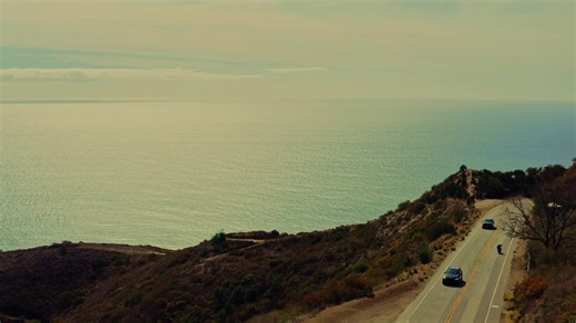 Boots sinking. Heavy. Wet sand. The wind tearing sideways — screaming. Ocean. Surfers — black needles against a bleeding sky. God, the colors. Blue. Grey. Slashing open the dark. Wool sweater heavy with salt. Terry sweatpants dragging at the knees. The sand and the wind. The machine. '48 Panhead sleeping half-awake. Slick with mist. Clutch gleaming like a broken tooth. Engine coughing, snarling, alive. Coast shaking. The day ripping wide, endless, wild. Heaven. Hell. It’s mine. I'm off. Black Be