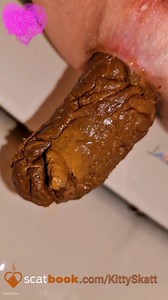 Brunette girl releasing big poop out of her ass as she stretches her holes