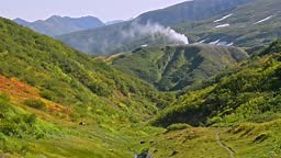 Geyser dan ekowisata. Avki Pilar uap air panas putih naik di atas...