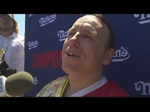 Joey Chestnut Wins 15th Mustard Belt, Takes Down Protestor