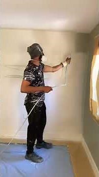 Painting wall with spray gun