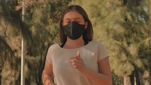 Woman wearing a face mask while jogging - Free Stock Video