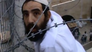 Settler seeking to remove Palestinian flag in Hebron gets tangled in barbed wire