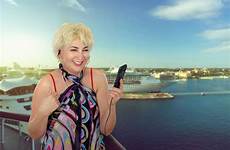 cruise ship mature woman enjoying happy single aged middle stock blond departing stands deck top model liner speaks video same
