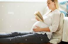 reading pregnant woman book alamy