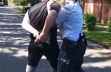 handcuffed escorted cop prisoner handcuff cops biceps