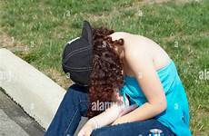 drunken teen alamy stock curb sits drinking edge street female after