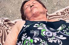 beach sunbathing woman old alamy senior stock sandy