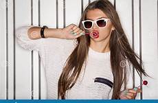 naughty girl young stock sucking lollipops outdoors portrait preview shutterstock