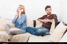cheating wife phone while husband talking waits privately alamy