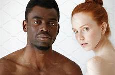 man woman young african looking male female redhead between caucasian mixed studio background race interracial people couple camera isolated posing