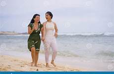 attractive relaxed enjoying korean holidays walking having couple together asian happy young beach beautiful women ethnicity friends