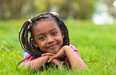girl young smiling african little girls outdoor cute portrait stock down long hair child pe outside hairstyles kids grass school