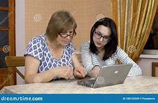 mother woman teaches laptop daughter computer shows young where use her old click