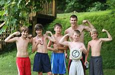 boys camp showing girls muscles