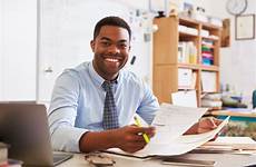 teacher african american desk male working portrait stock preview