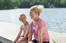 mature son woman sitting pier during happy vacations dissolve stock d929 maskot