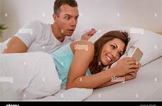 cheating wife husband phone her using bed stock mobile catching alamy talking