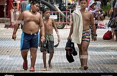 shirtless boys thailand street walking along young friends southeast three asia alamy outside log stock