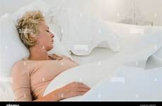 sleeping mature woman bed alamy
