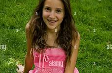 braces girl young teenage dress sitting smiling pink stock alamy