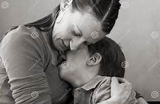 son crying mother hugs old hugging her stock