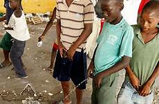 peeing pee urinate haitian haiti mob slum religious
